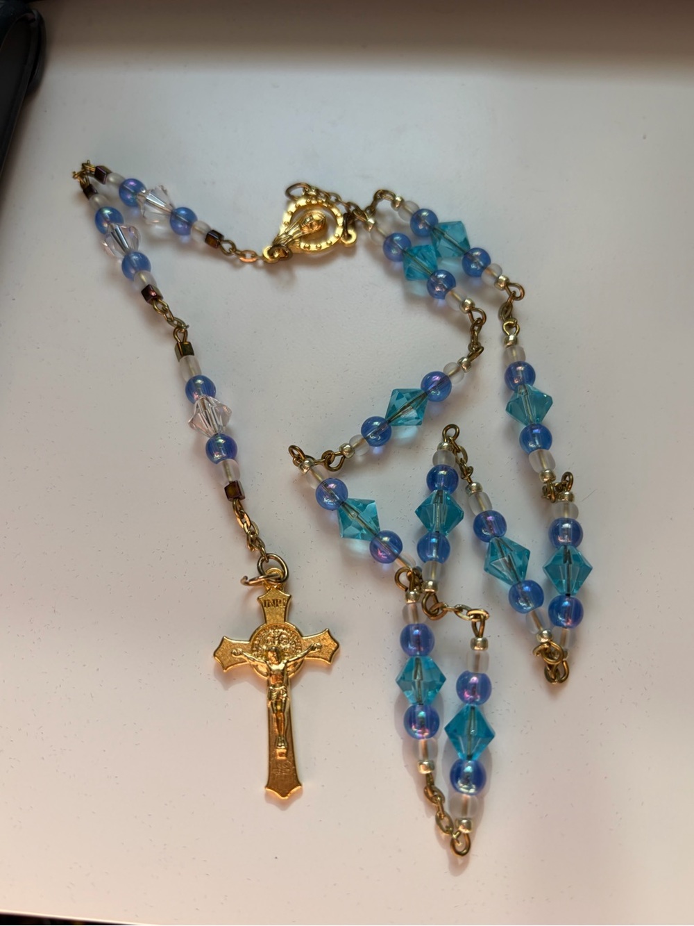 4/$100 Gold-Tone Crucifix Rosary Necklace with Blue Beads